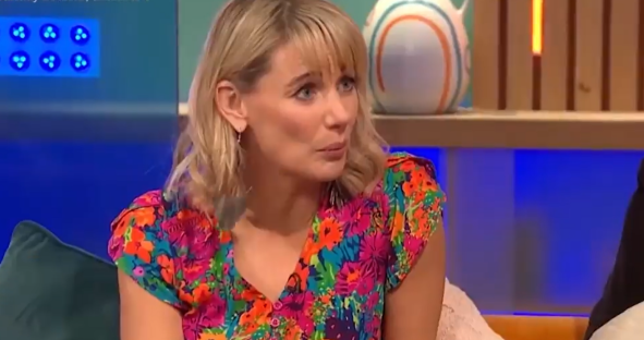 Woman in floral dress on television show.