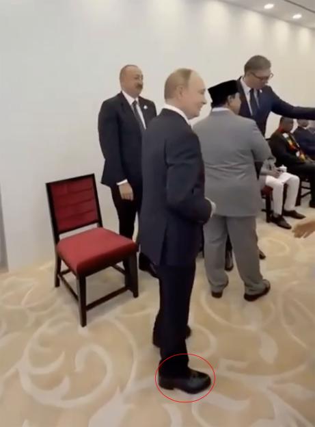 Vladimir Putin wearing platform heels.