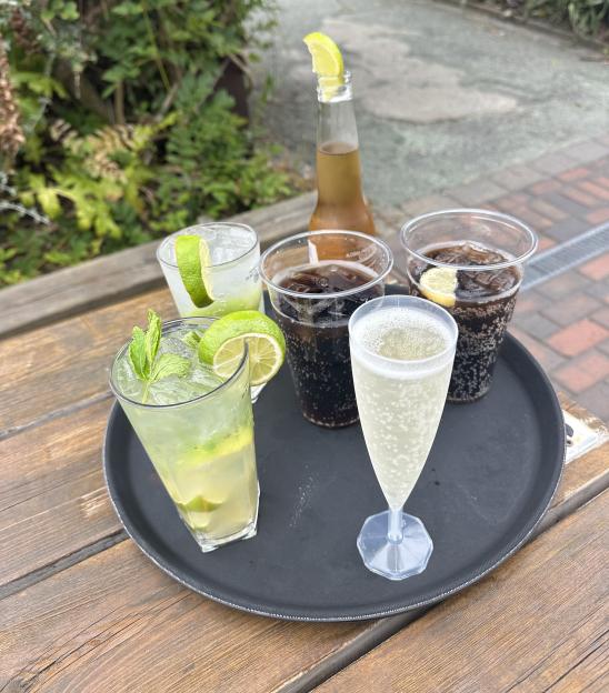 Tray of drinks including cocktails and soda.