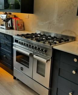 Instagram post showing a Bertazzoni range cooker in a dark kitchen.