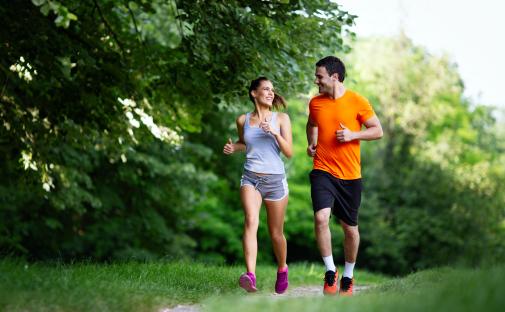 Happy couple jogging outdoors.