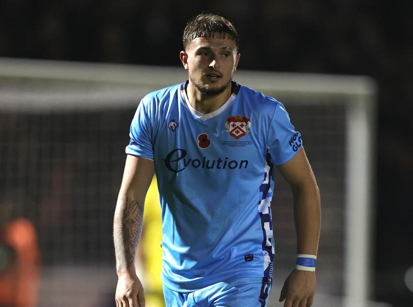 Lewis White of Kettering Town in action during an FA Cup match.