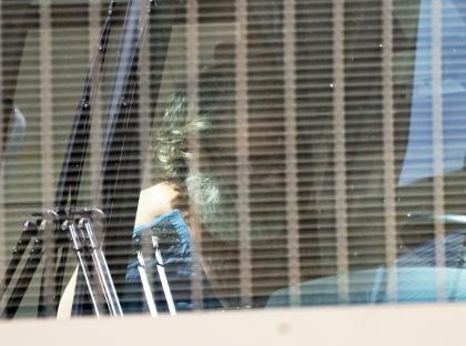 Photo of Jimmy Carwyle on a bus leaving a courthouse.