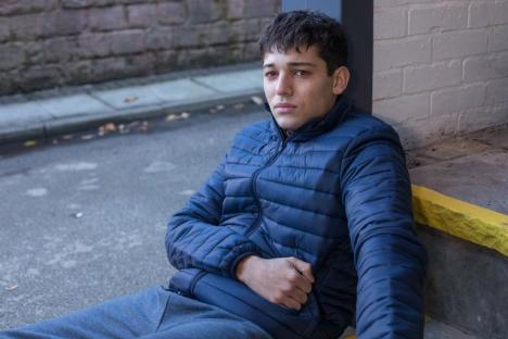Billy Price, portraying Sid Sumner in Hollyoaks, sits looking pensive.