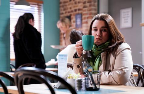 Alice Haig as Vicki Fowler in EastEnders, drinking tea in a cafe.