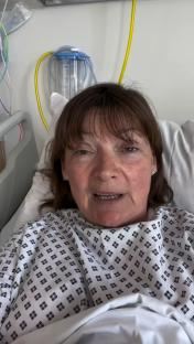 Lorraine Kelly recovering in a hospital bed after keyhole surgery.