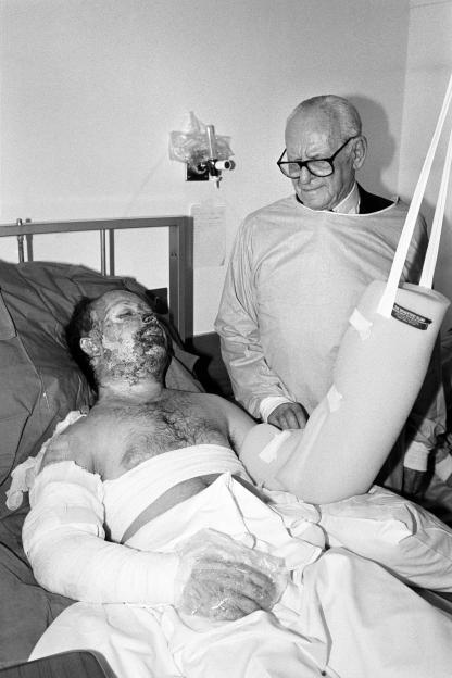 Dr. Armand Hammer visiting a Piper Alpha survivor in the hospital.