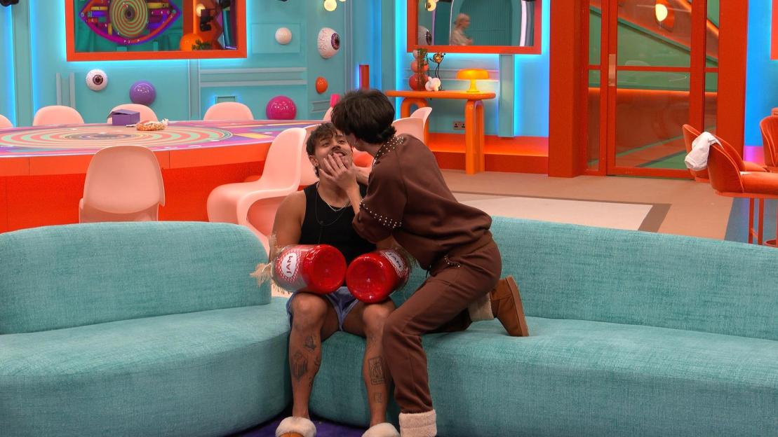 Zelah touches Sam's face in the Big Brother house.