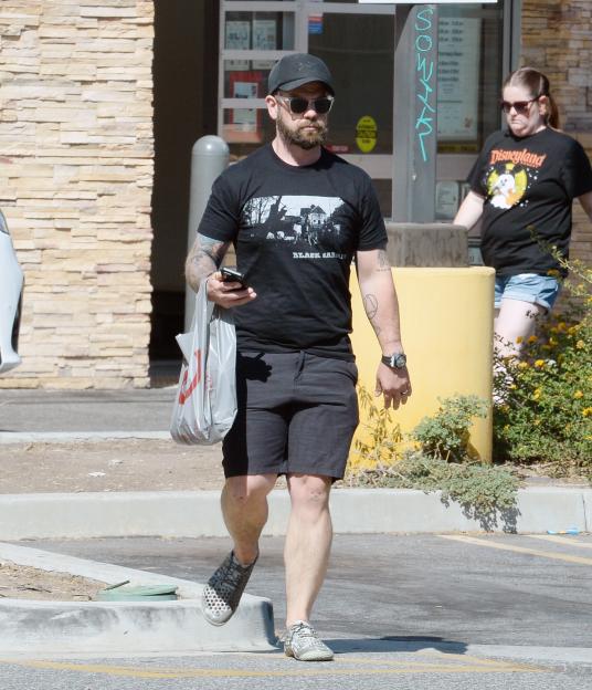 Jack Osbourne walking in a parking lot, wearing a Black Sabbath t-shirt.