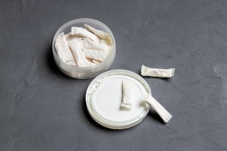 Nicotine pouches in a container.