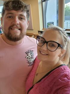 Photo of a man and woman smiling for the camera.