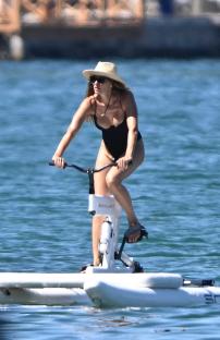 Gisele Bündchen riding a water bike.