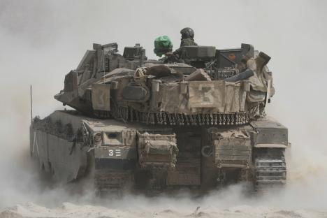 Israeli soldiers operating a tank near the Gaza Strip border.