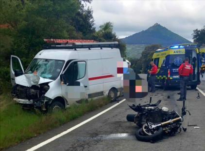 Accident scene showing a damaged van and motorcycle.