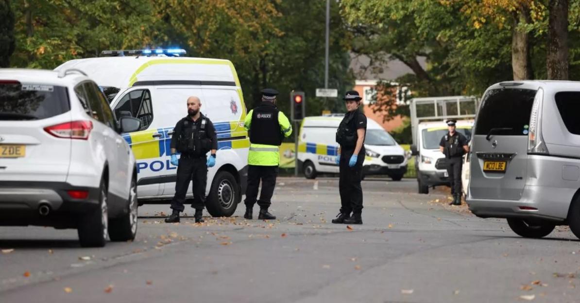 Police officers and vehicles on Middleton Road following a stabbing at a Manchester synagogue.