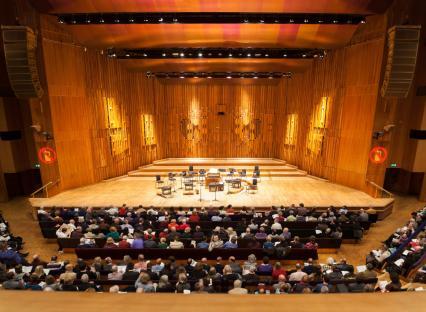 CN0Y63 Empty music stage of the Barbican Centre Concert Hall Theatre Theater Auditorium London. With audience public visitors people.