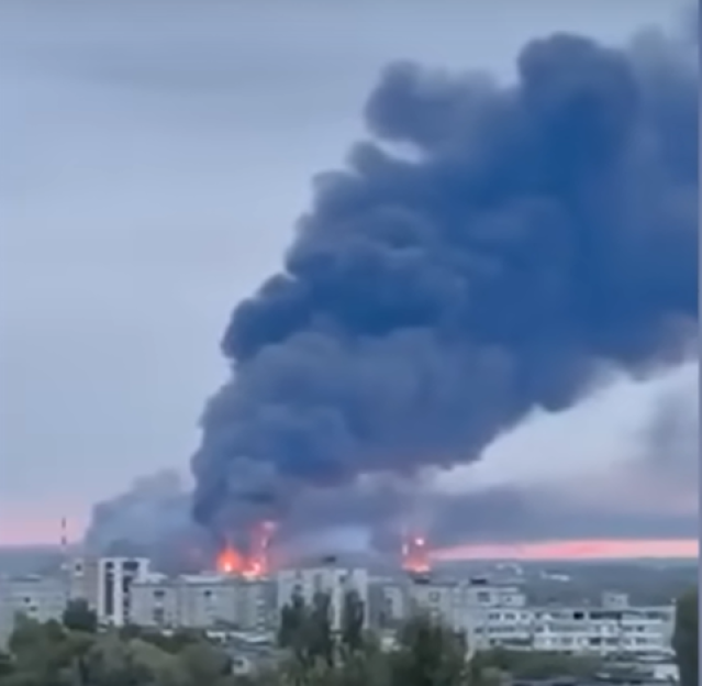 A large fire and dark smoke rising from a building.