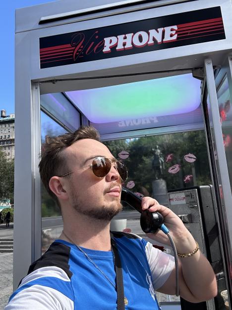 Man on phone in a ViePhone booth.