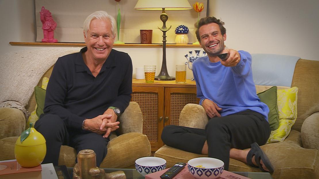 Married couple Andrew and Alfie from the Cotswolds sitting on a couch.