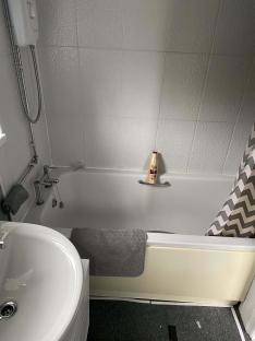 Bathroom with bathtub, sink, and shower.