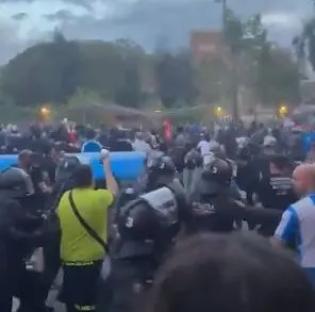 A car driving into a large crowd of people.
