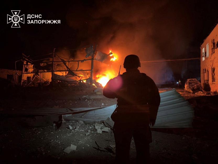 A firefighter examining a burning building after an overnight strike.