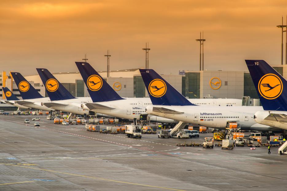 Several Lufthansa airplanes parked at Frankfurt International Airport.