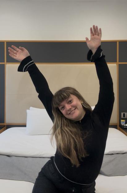 Cyann Fielding at Z Hotels Gloucester Place, smiling with arms raised.