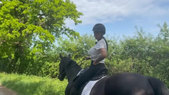 Woman horseback riding.
