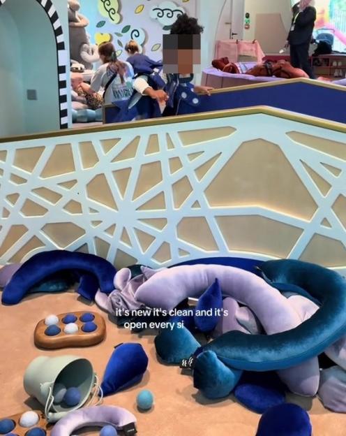 Play space with colorful soft objects on the floor, children playing in the background, and the text "South London's Newest Play Space" and "it's new it's clean and it's open every si".