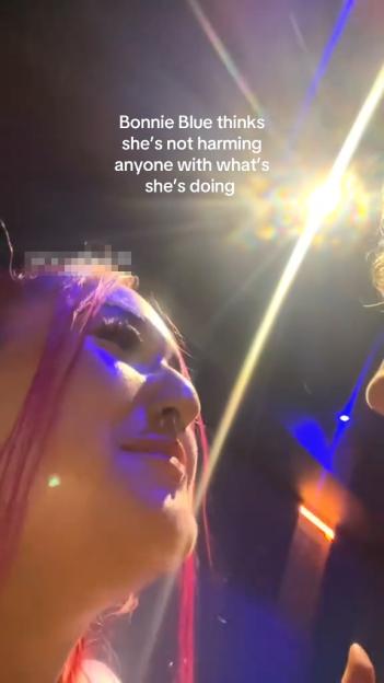 A video grab of a woman with pink hair, captioned "Bonnie Blue thinks she's not harming anyone with what she's doing."