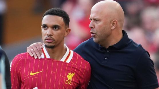 Liverpool player and coach conferring.