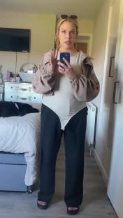 Woman realizing her outfit is mismatched after returning home from school.