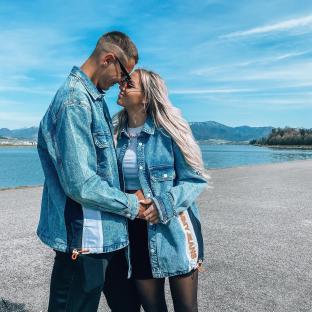 Couple embracing near a lake.