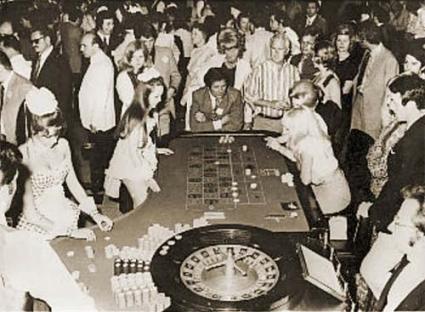 Illustration of a crowded casino with people playing roulette.