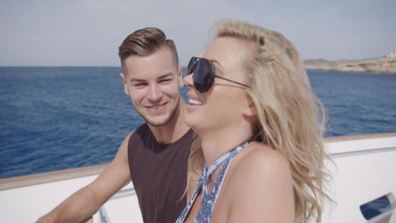 Couple smiling on a boat.