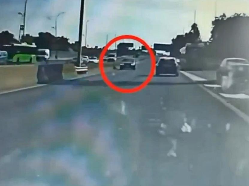 Dashcam footage of a car driving the wrong way on a motorway.