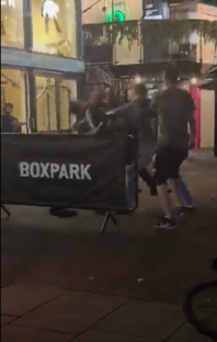 Shock moment bouncer is punched to the floor by rowdy pubgoer as pair grapple in late-night brawl outside busy venue