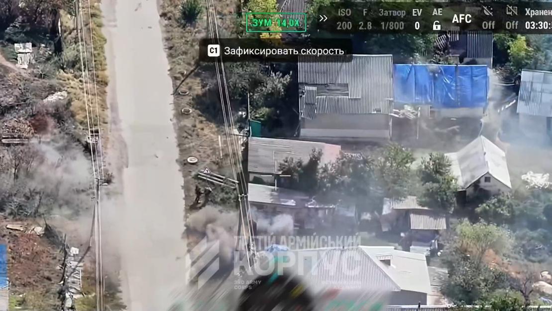 Aerial view of a Ukrainian village with smoke visible near houses and a road, showing Russian forces taking a girl hostage.