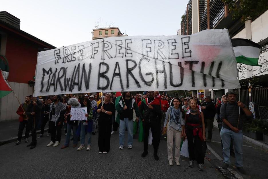 People protest with a banner that reads "FREE FREE FREE MARWAN BARGHOUTI"