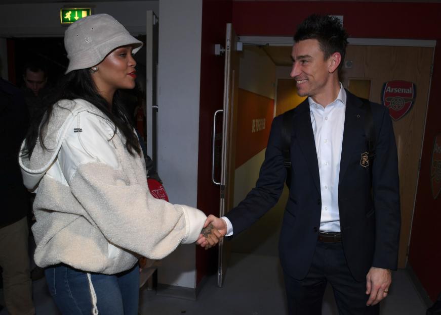 Rihanna shaking hands with Arsenal's Laurent Koscielny.