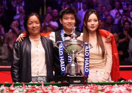 Zhao Xintong of China with his girlfriend and mother after winning a snooker championship.