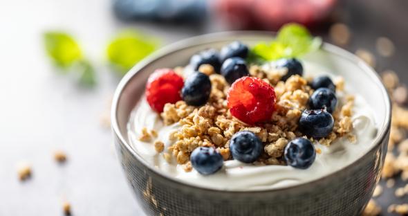 Yogurt bowl with granola, raspberries, and blueberries.