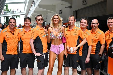 Model Veronika Rajek with McLaren F1 Team members.