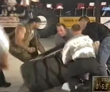 People assisting an injured strongman.
