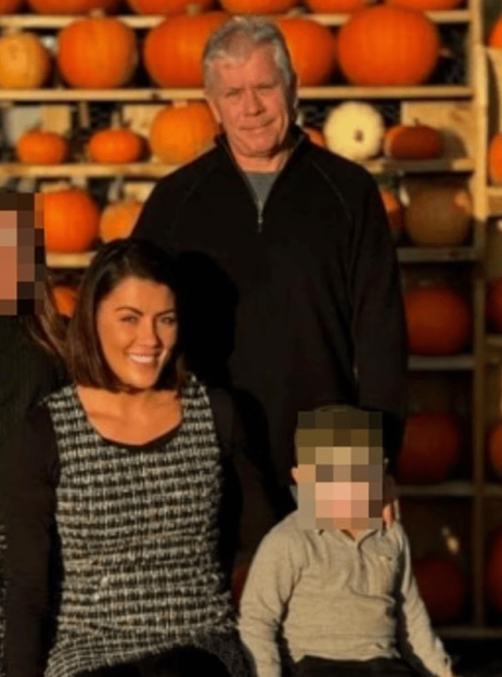 Family portrait in front of pumpkins.