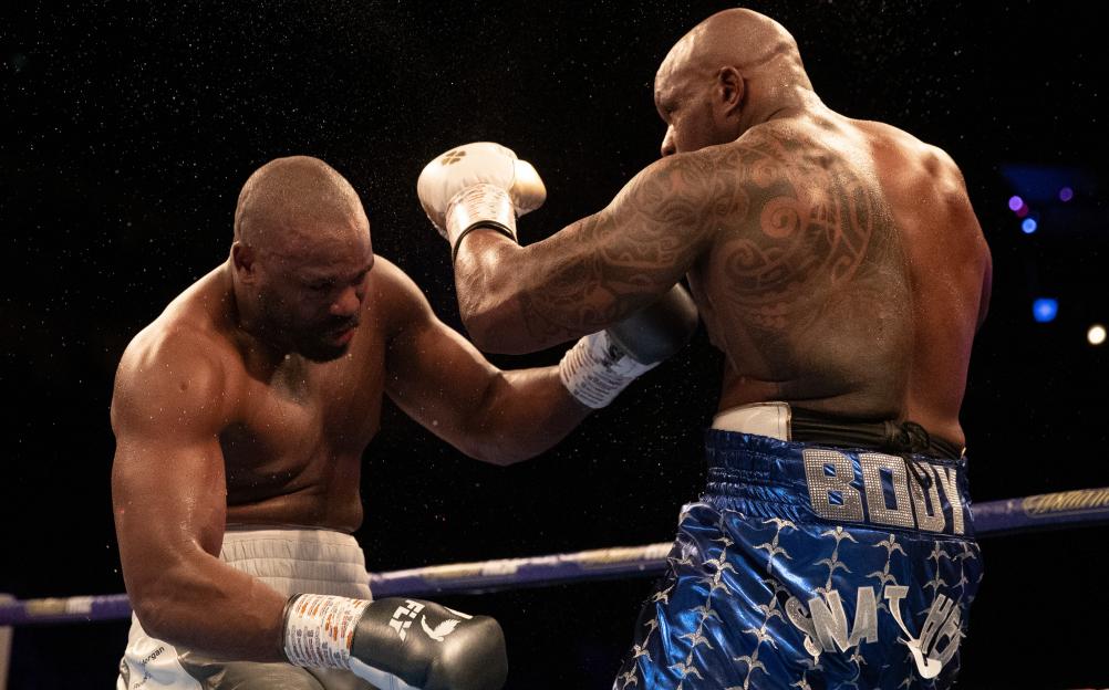 Dillian Whyte (right) punches Dereck Chisora (left) in a boxing match.