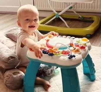 Baby playing with activity table.
