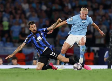 Erling Haaland of Manchester City vying for the ball with an Inter Milan player.