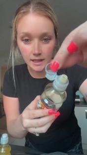 Woman demonstrating a child-safe bottle cap.